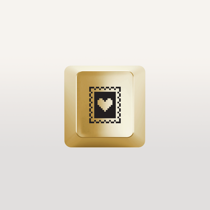 Love stamp Key by Susan Kare in Gold - Gold keyboard key featuring a &quot;Love stamp&quot; icon design by Susan Kare